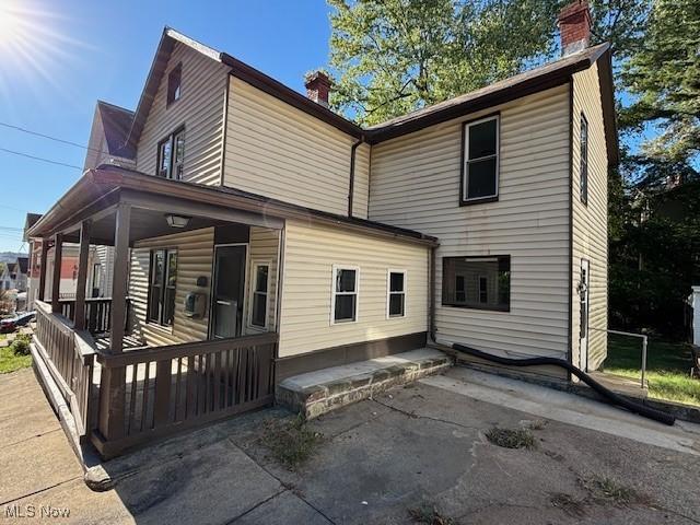 805 Quarry St, Marietta, OH 45750 - view of property exterior with a chimney and a porch