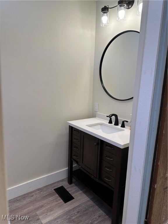 bathroom with vanity and hardwood / wood-style floors