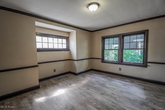 unfurnished room with ornamental molding and dark hardwood / wood-style floors