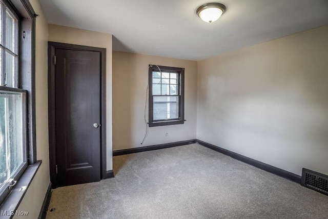 unfurnished bedroom with a closet and carpet floors