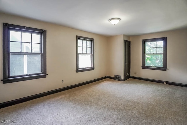 carpeted empty room featuring a healthy amount of sunlight