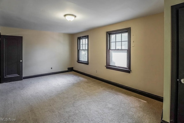 spare room featuring light colored carpet