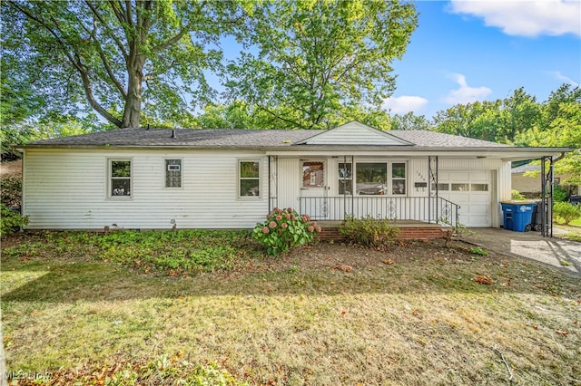 ranch-style home with a garage and a front lawn