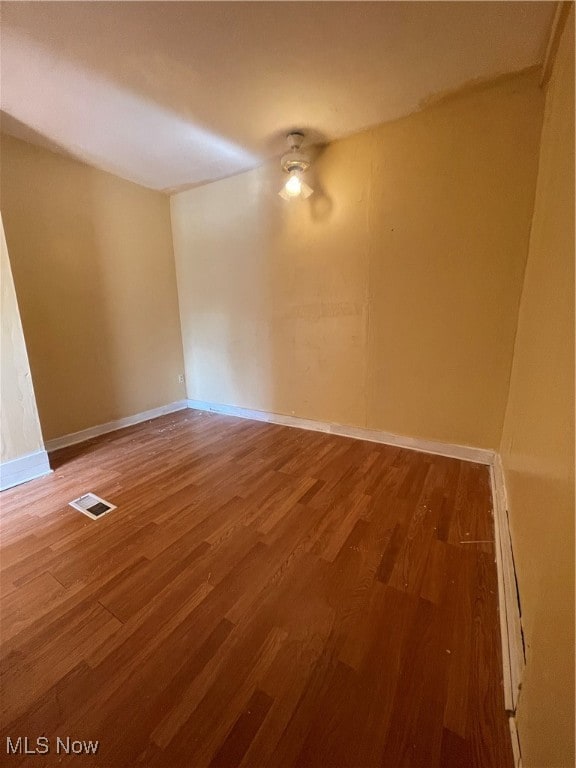 spare room featuring hardwood / wood-style flooring