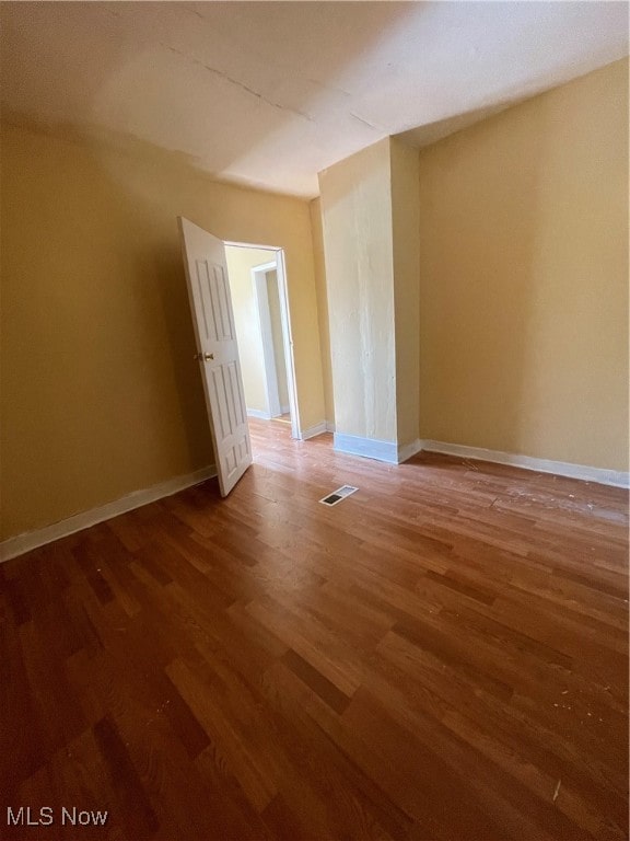 empty room with wood-type flooring