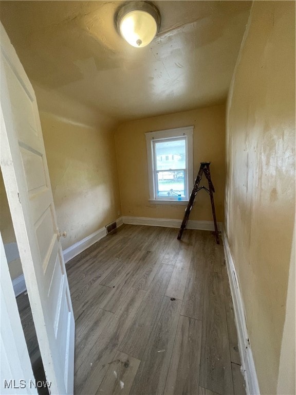 additional living space featuring hardwood / wood-style flooring