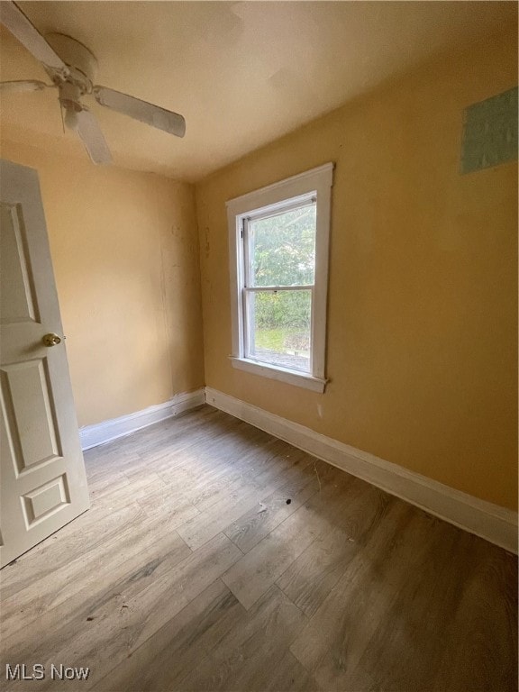 spare room featuring ceiling fan and light hardwood / wood-style floors