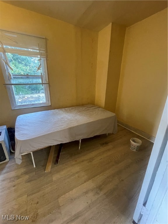 bedroom with hardwood / wood-style flooring