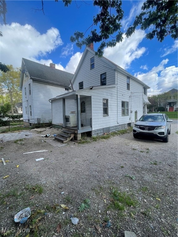 back of property with covered porch