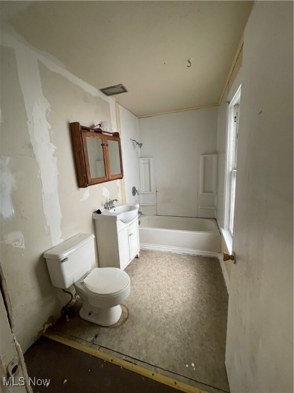 full bathroom with bathtub / shower combination, vanity, and toilet