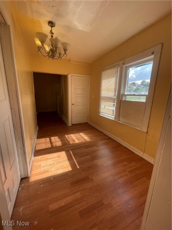 interior space featuring hardwood / wood-style flooring and a notable chandelier