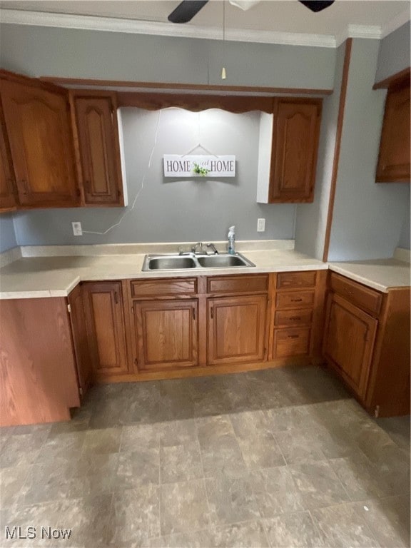 kitchen featuring ornamental molding, sink, and ceiling fan