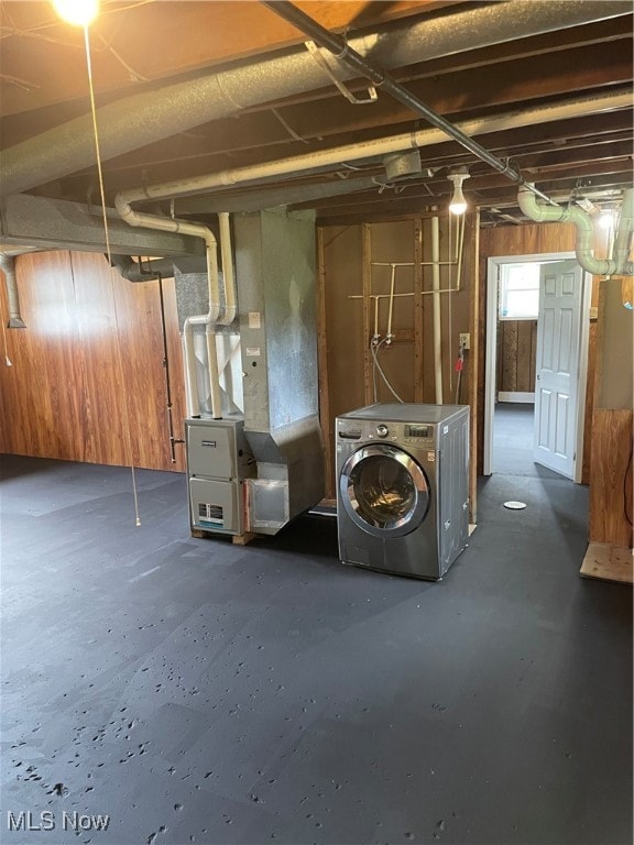 basement with washer / clothes dryer and heating unit