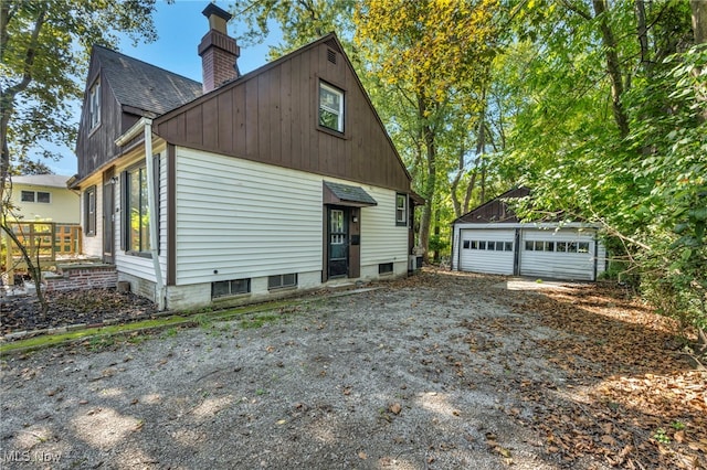 view of property exterior featuring an outdoor structure and a garage