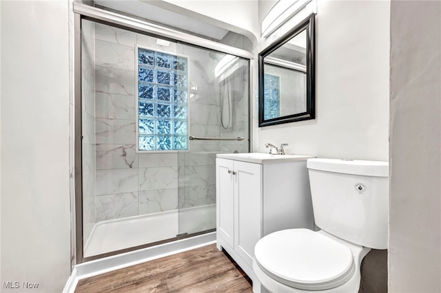 bathroom with vanity, hardwood / wood-style floors, toilet, and an enclosed shower