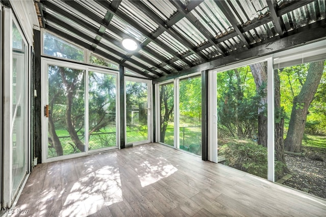 unfurnished sunroom with vaulted ceiling and a wealth of natural light