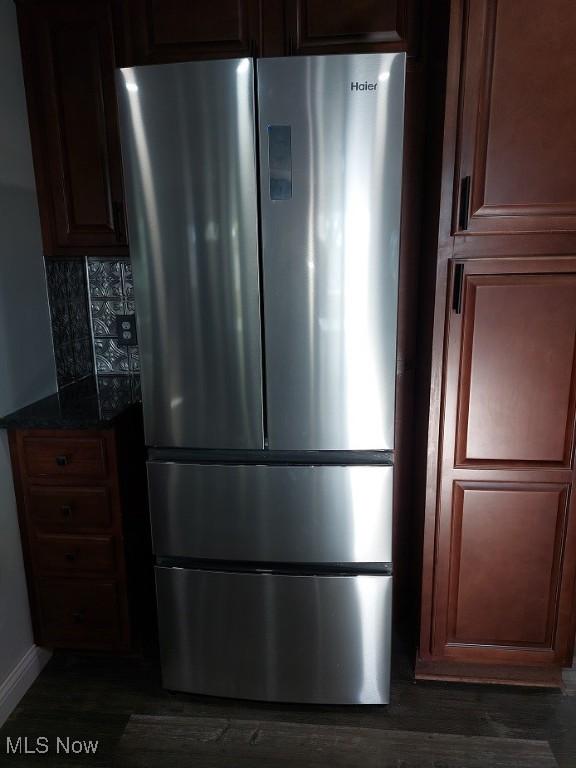 139 Patterson Rd, Weirton, WV 26062 - details with dark stone countertops, freestanding refrigerator, decorative backsplash, and dark wood-type flooring