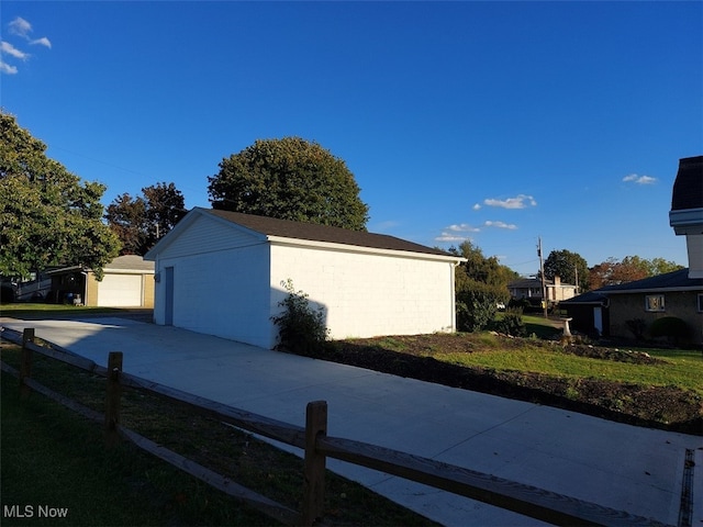 view of property exterior with an outbuilding