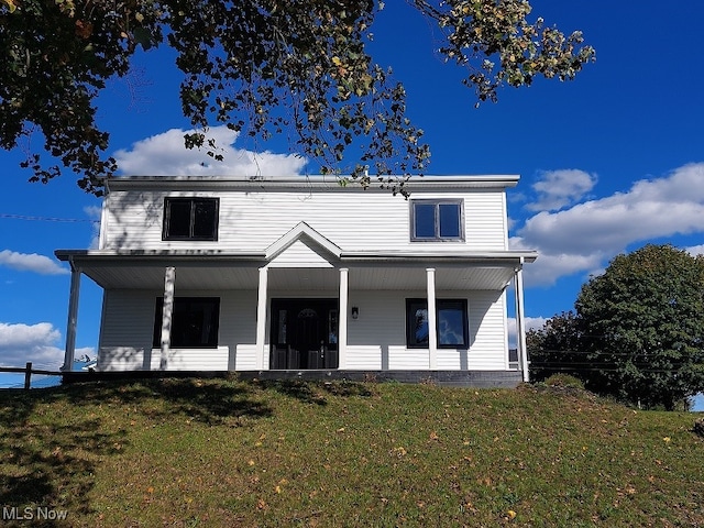 view of front of home with a front yard and a porch