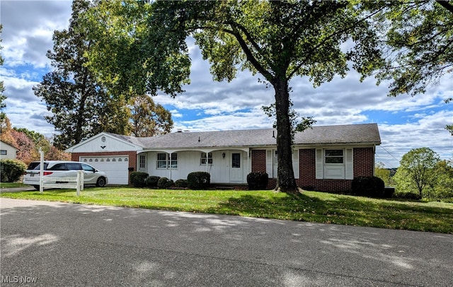 single story home with a front yard and a garage