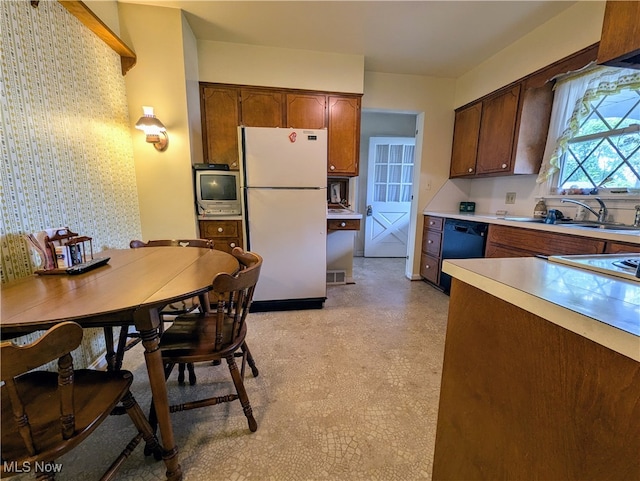 kitchen with white refrigerator, dishwasher, and sink