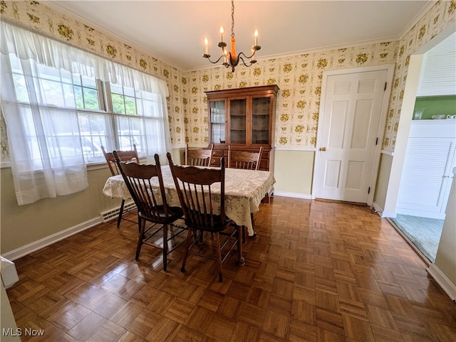 dining room with dark parquet floors, crown molding, and an inviting chandelier