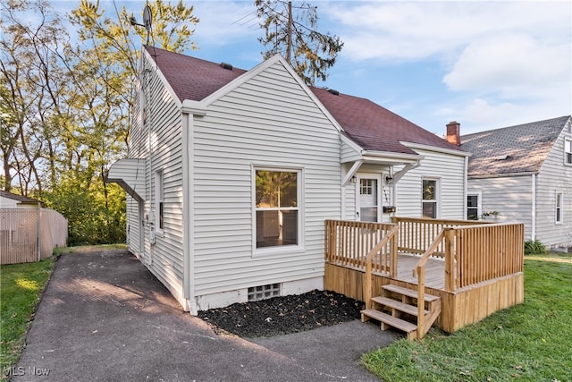 back of house with a wooden deck