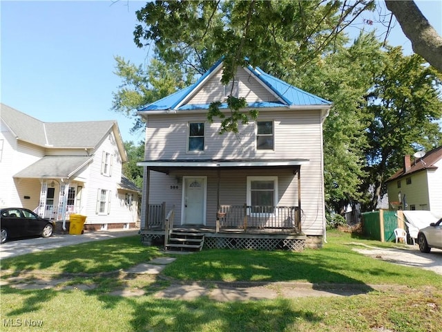 386 Jackson St, Conneaut, OH 44030 - traditional style home with a front lawn, covered porch, and metal roof