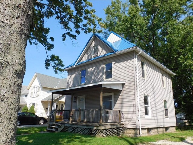 386 Jackson St, Conneaut, OH 44030 - back of house with a porch and a lawn