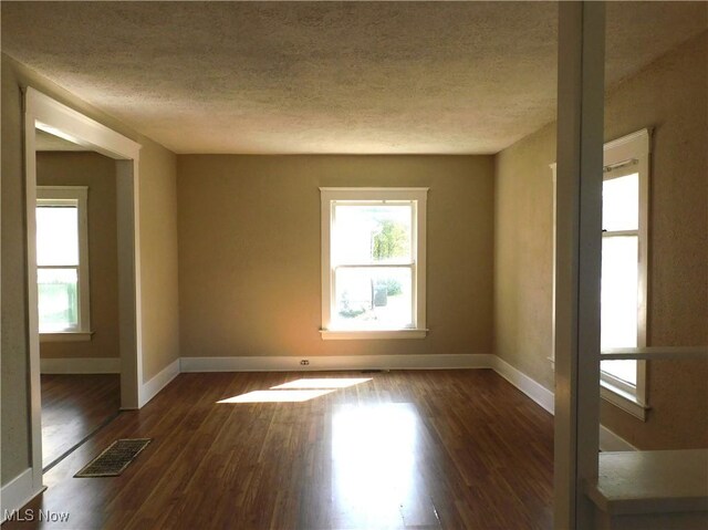 386 Jackson St, Conneaut, OH 44030 - empty room featuring a textured ceiling, baseboards, visible vents, and plenty of natural light