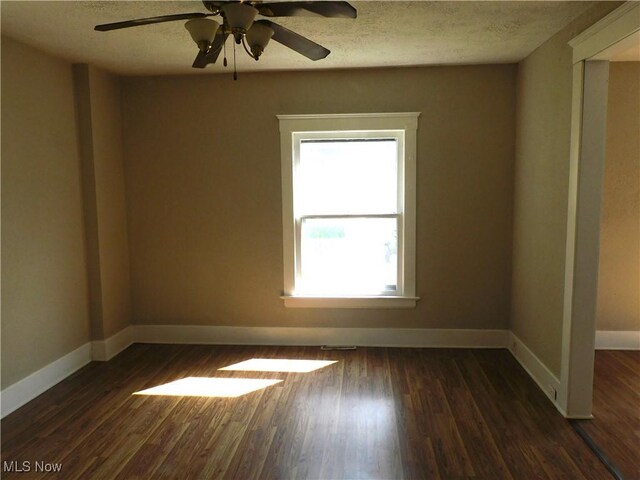 386 Jackson St, Conneaut, OH 44030 - empty room with a textured ceiling, baseboards, ceiling fan, and dark wood-style floors