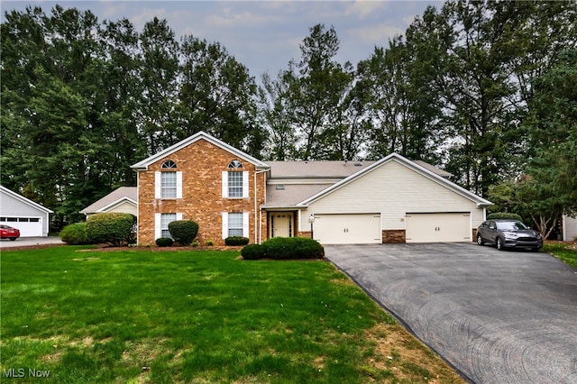 view of front of property with a front yard and a garage