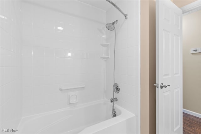 bathroom with wood-type flooring and tiled shower / bath combo