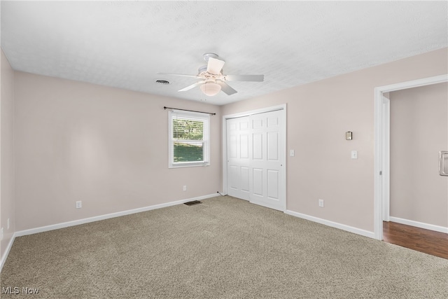 unfurnished bedroom with ceiling fan, a closet, and carpet