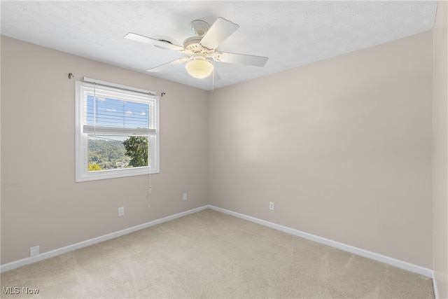 carpeted empty room featuring a textured ceiling and ceiling fan