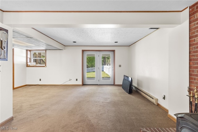 carpeted spare room with a textured ceiling, baseboard heating, and ornamental molding