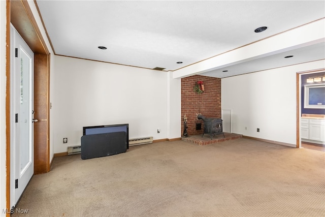 unfurnished living room featuring light carpet, baseboard heating, and a wood stove