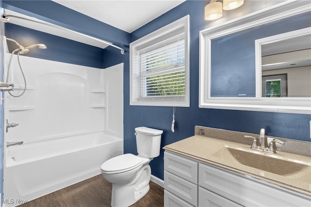 full bathroom featuring tub / shower combination, vanity, toilet, and wood-type flooring