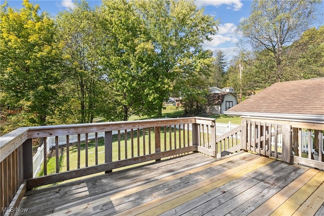 deck featuring a yard and a storage unit