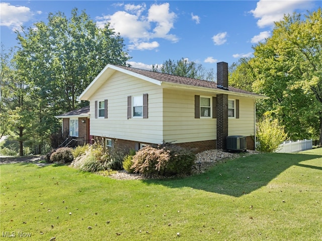 view of home's exterior with central AC and a lawn