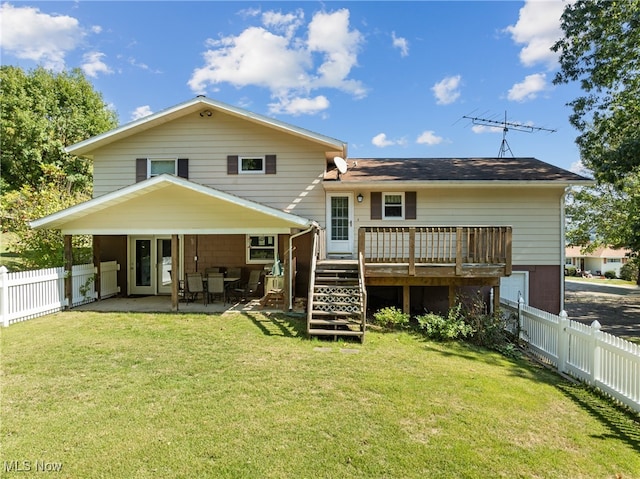 rear view of property featuring a patio, a yard, and a wooden deck