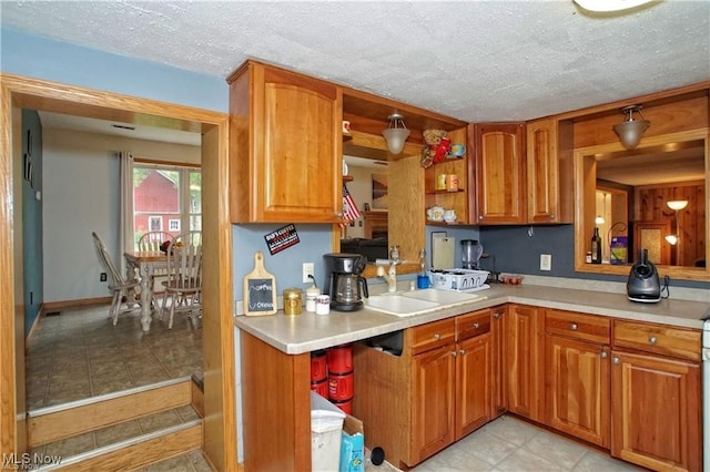 kitchen with sink and a textured ceiling