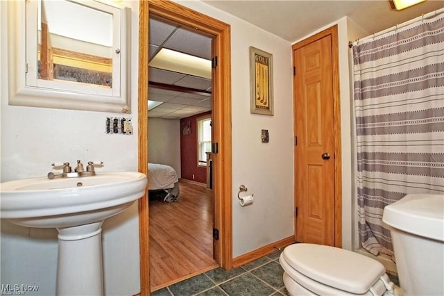 bathroom featuring toilet, sink, a paneled ceiling, hardwood / wood-style floors, and a shower with shower curtain