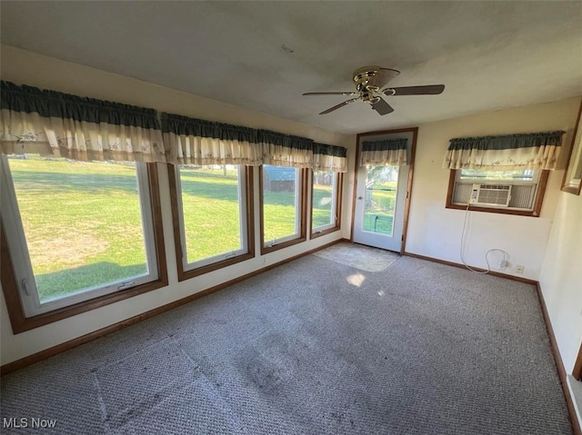 unfurnished sunroom featuring plenty of natural light, cooling unit, and ceiling fan