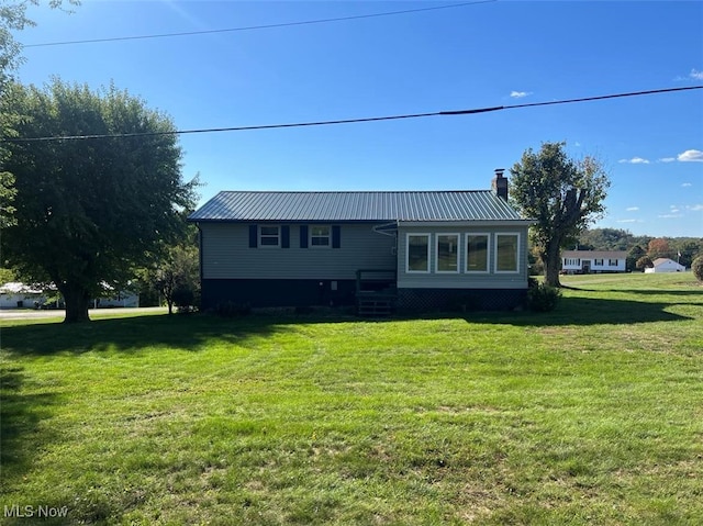 rear view of house with a lawn