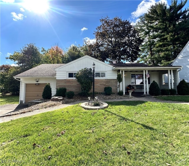 ranch-style house with a front lawn, a porch, and a garage