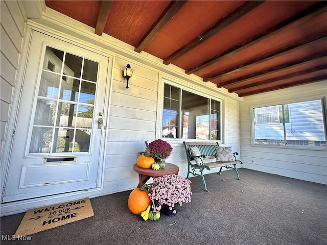 exterior space with beamed ceiling and a wealth of natural light