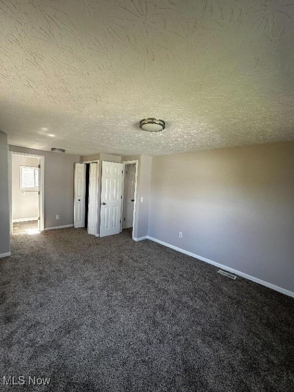 unfurnished bedroom featuring carpet floors and a textured ceiling