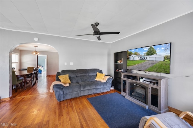 living room featuring ceiling fan, ornamental molding, and hardwood / wood-style floors