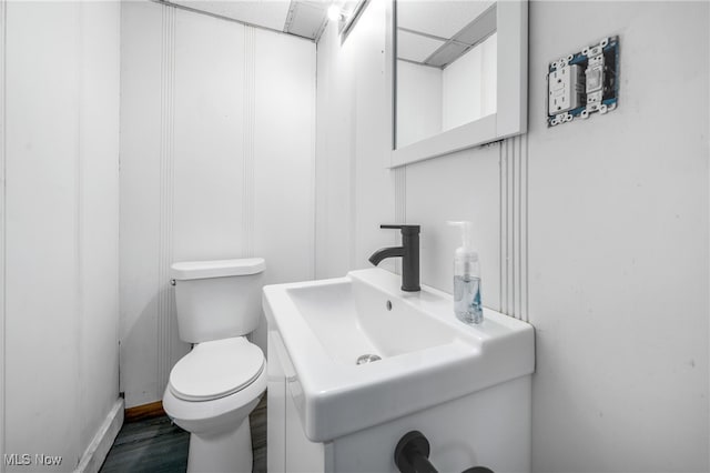 bathroom with wood-type flooring, sink, and toilet